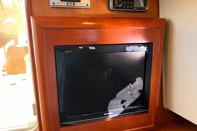 Slide: The Image of 2009 Mainship Pilot 31 interior with built-in Sharp Aquos TV and audio system. - 17