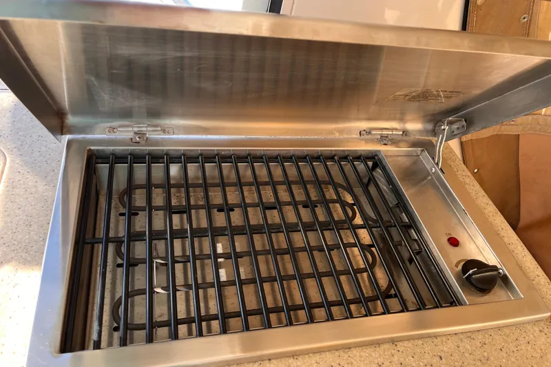 Slide: The Image of Stainless steel grill on Mainship Pilot 31 boat, 2009 model, with open lid and control knob. - 25