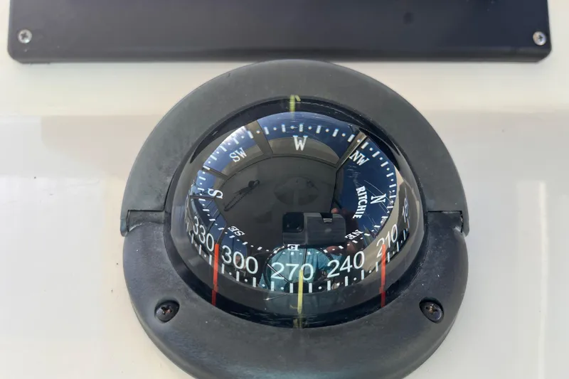 Slide: The Image of Compass on 2009 Mainship Pilot 31 boat dashboard, showing direction and degrees. - 27
