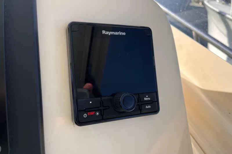 Slide: The Image of Raymarine control panel on 2009 Mainship Pilot 31 boat dashboard. - 32