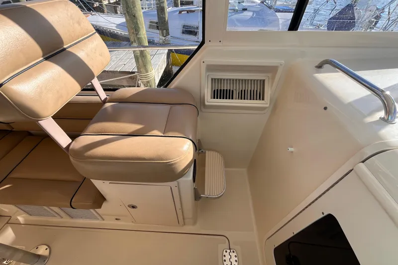 Slide: The Image of 2009 Mainship Pilot 31 interior with tan seating and window view. - 35