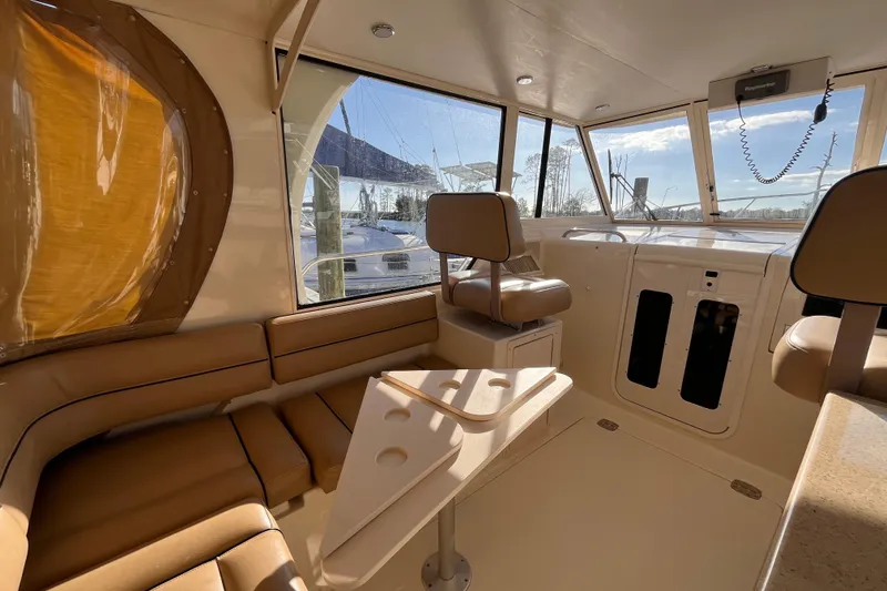 Slide: The Image of Interior of 2009 Mainship Pilot 31 boat with beige seating and helm station. - 41