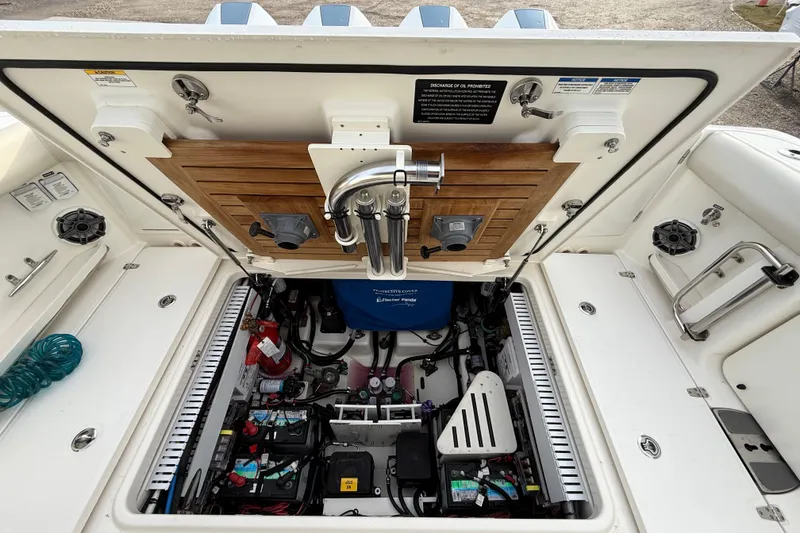 Slide: The Image of 2021 Boston Whaler 380 Realm engine compartment with open hatch, showcasing detailed components. - 10