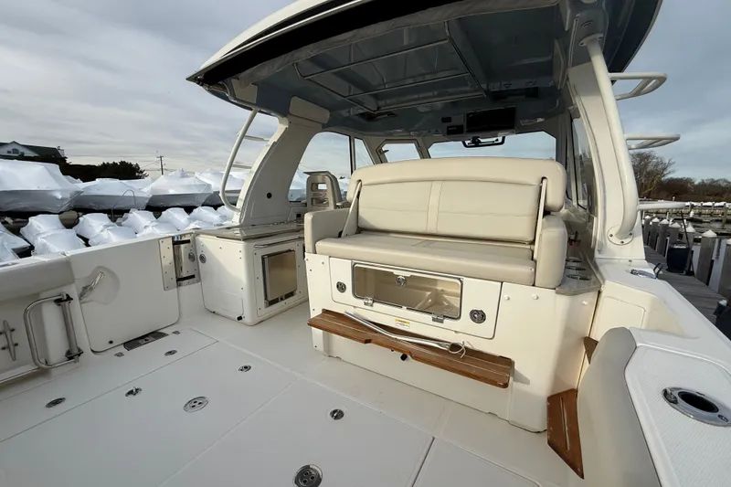 Slide: The Image of 2021 Boston Whaler 380 Realm boat interior with seating and storage. - 13