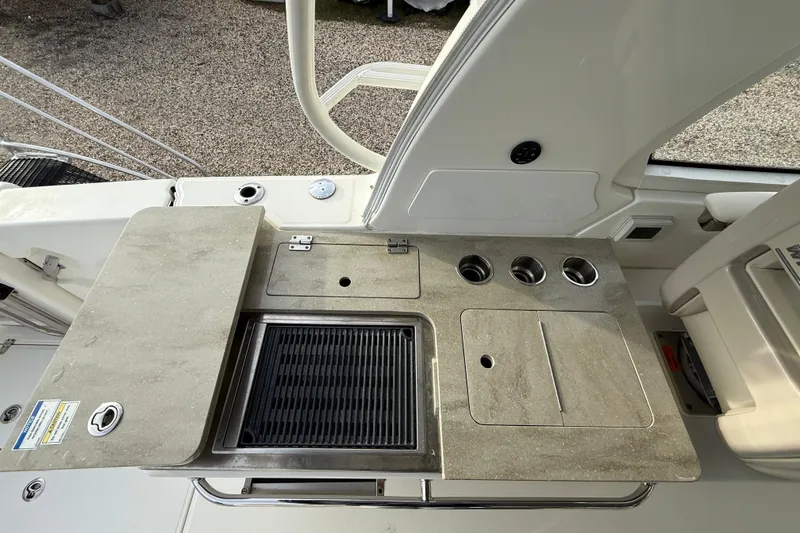 Slide: The Image of 2021 Boston Whaler 380 Realm boat kitchen area with grill and countertop. - 15