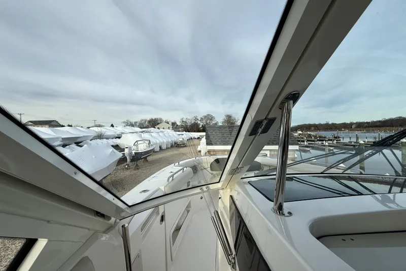 Slide: The Image of 2021 Boston Whaler 380 Realm boat docked, view from cockpit, marina in background. - 20