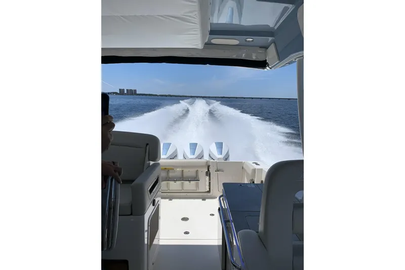 Slide: The Image of 2021 Boston Whaler 380 Realm cruising on open water, view from cockpit. - 24