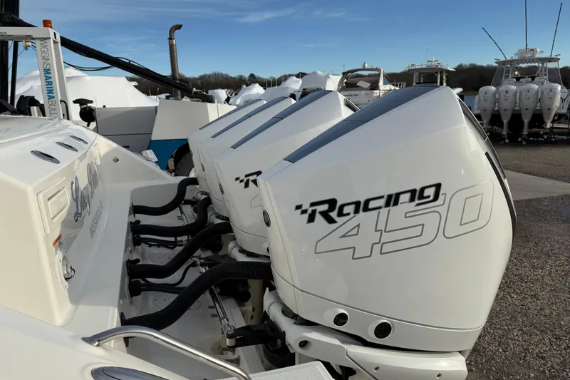 Slide: The Image of 2021 Boston Whaler 380 Realm with powerful Racing 450 engines docked at a marina. - 6