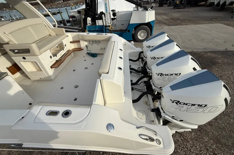 Slide: The Image of 2021 Boston Whaler 380 Realm with triple Racing 450 engines, docked at marina. - 8