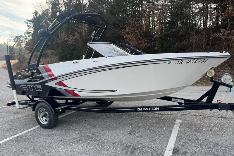 Slide: The Image of 2015 Glastron GTS 187 boat on trailer, parked in wooded area. - 13