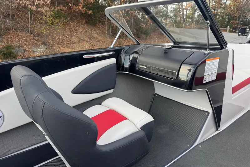 Slide: The Image of 2015 Glastron GTS 187 boat interior with black and red seating, dashboard view. - 22