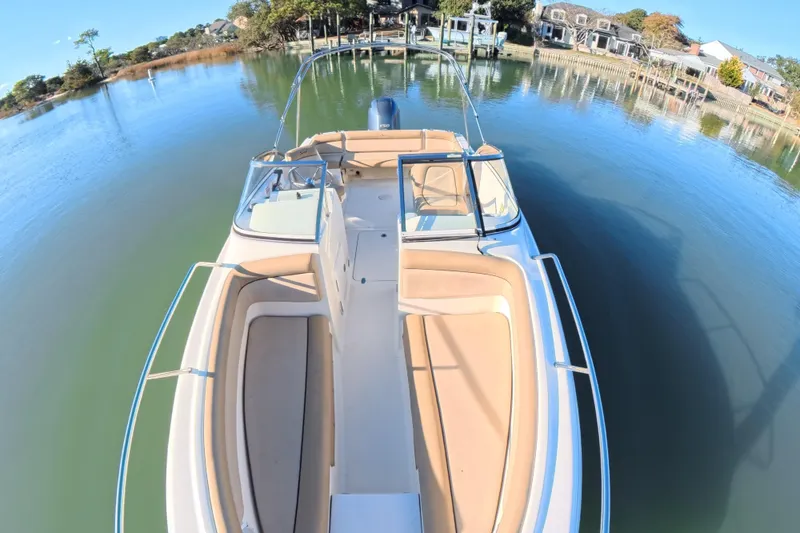 Slide: The Image of 2017 Scout 210 Dorado boat on calm water, featuring spacious seating and sleek design. - 13