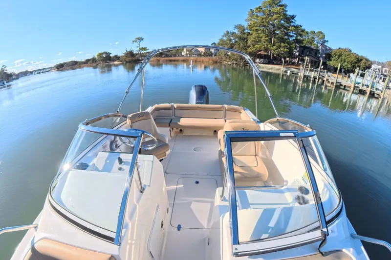 Slide: The Image of 2017 Scout 210 Dorado boat on calm water, featuring spacious seating and clear skies. - 14