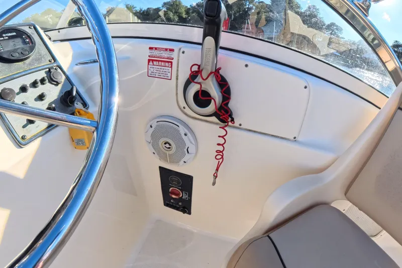 Slide: The Image of 2017 Scout 210 Dorado boat dashboard with steering wheel and control panel. - 21