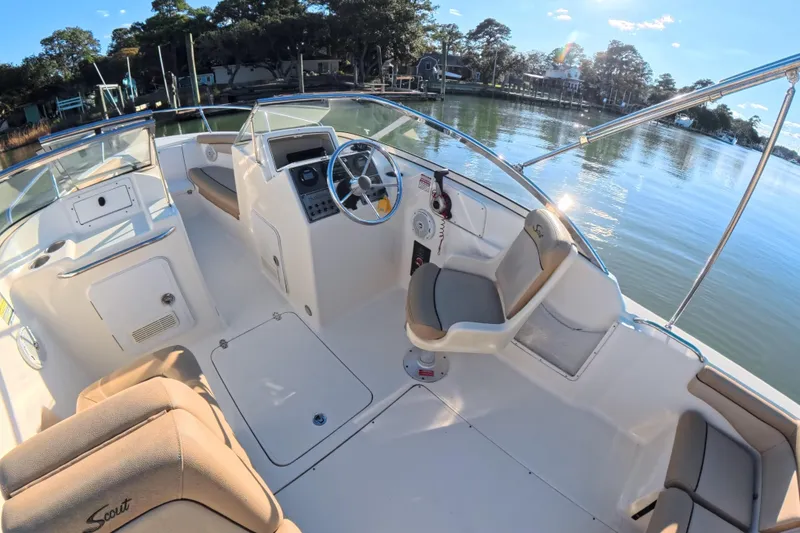 Slide: The Image of Interior view of 2017 Scout 210 Dorado boat, featuring helm and seating area. - 23
