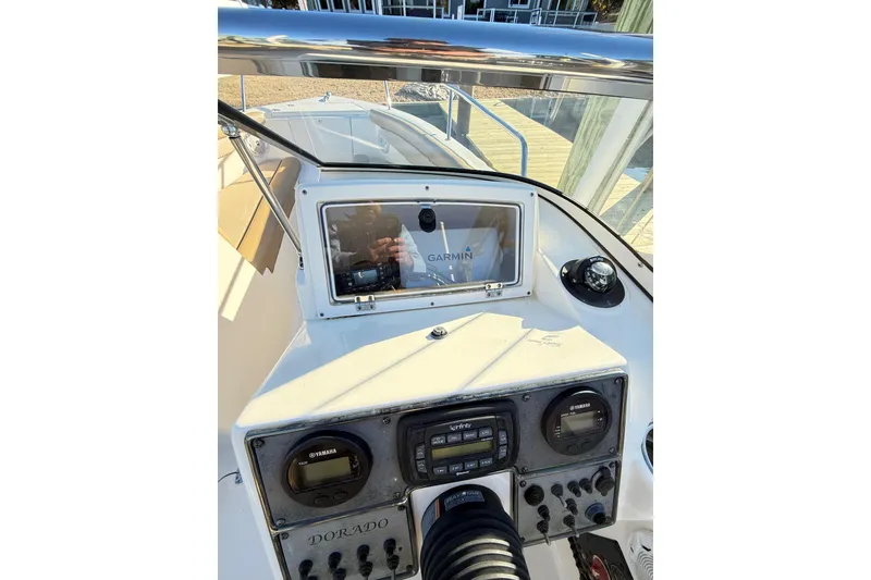 Slide: The Image of 2017 Scout 210 Dorado boat dashboard with Garmin navigation system and Yamaha controls. - 25