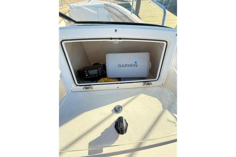 Slide: The Image of 2017 Scout 210 Dorado boat compartment with Garmin equipment inside. - 27
