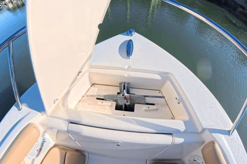 Slide: The Image of 2017 Scout 210 Dorado boat anchor compartment open on calm water. - 34