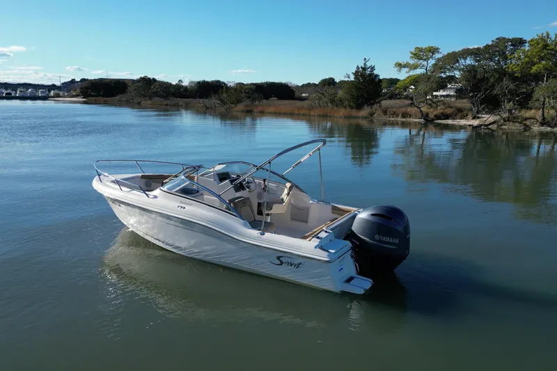 Slide: The Image of 2016 Scout 210 Dorado boat on calm water with Yamaha outboard motor. - 4
