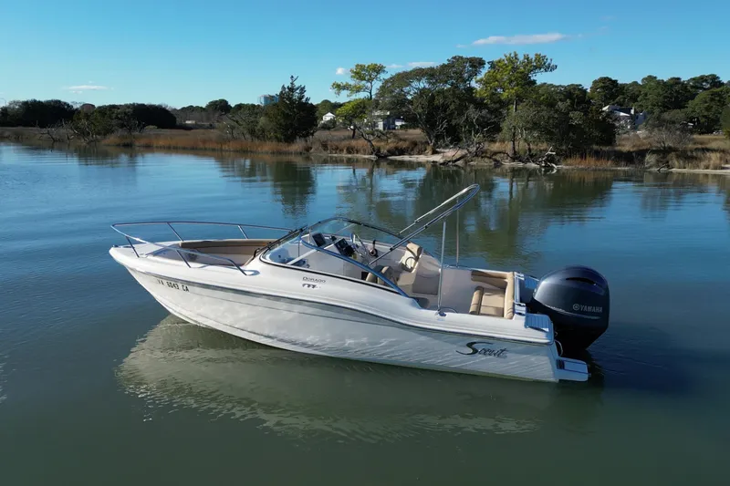 Slide: The Image of 2016 Scout 210 Dorado boat on calm water with scenic background. - 5