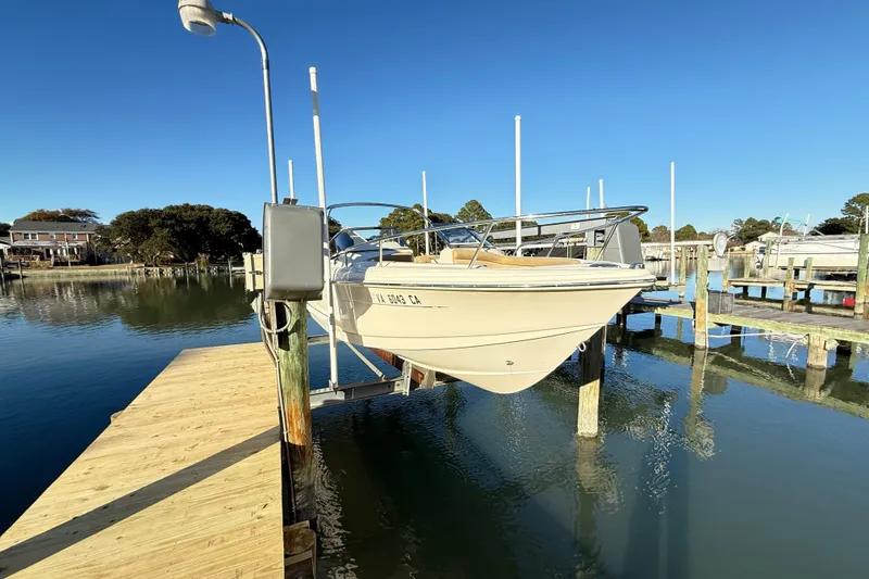 Slide: The Image of 2017 Scout 210 Dorado boat docked on a sunny day at a marina. - 7