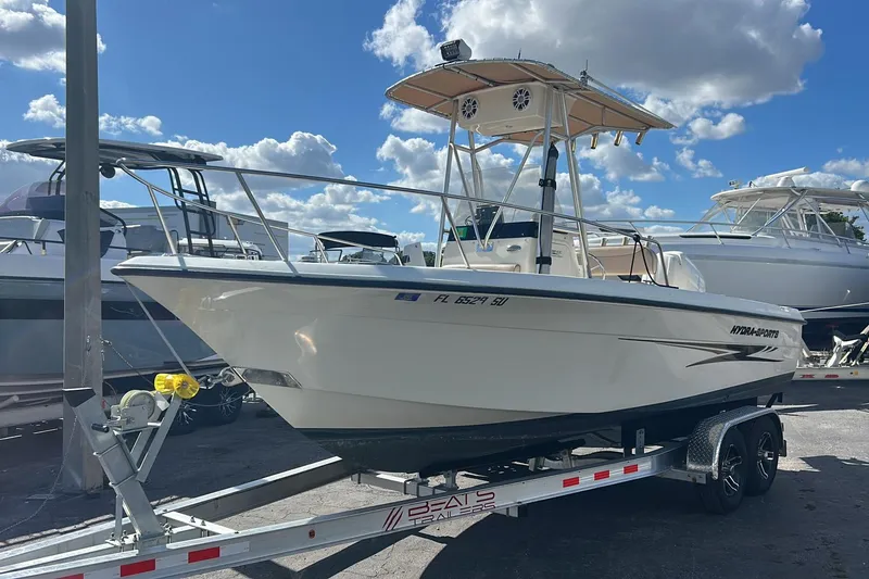 The Image of 2005 Hydra-Sports 212 CC boat on trailer under blue sky with clouds. - 1