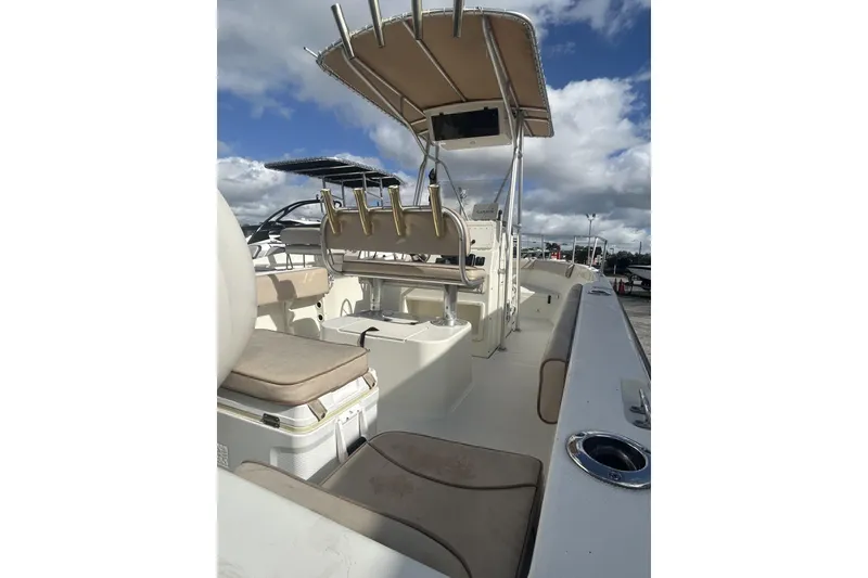 Slide: The Image of 2005 Hydra-Sports 212 CC boat interior with seating and console under a cloudy sky. - 10