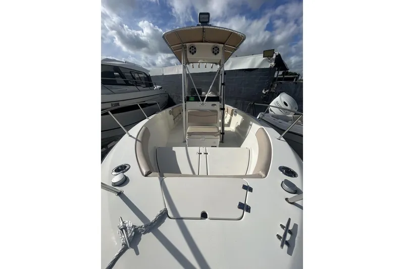Slide: The Image of 2005 Hydra-Sports 212 CC boat, open deck view, under cloudy sky. - 4