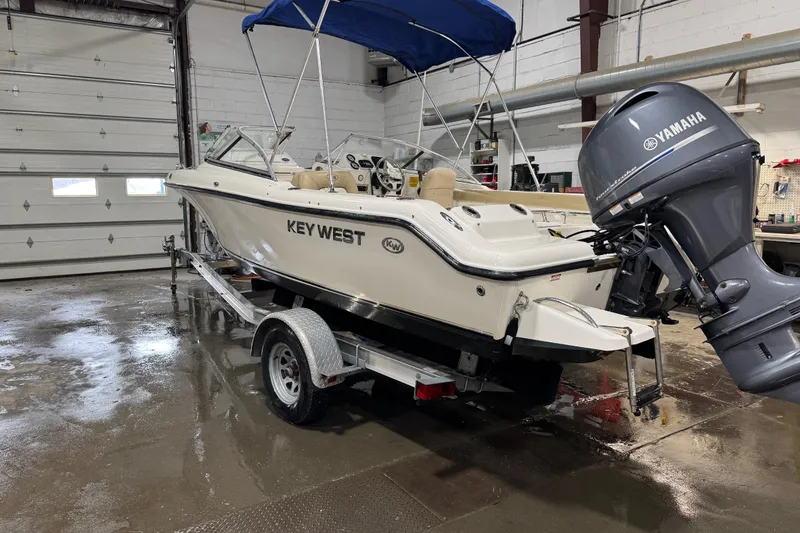 The Image of 2015 Key West 186 Dual Console boat with Yamaha engine in a garage setting. - 0