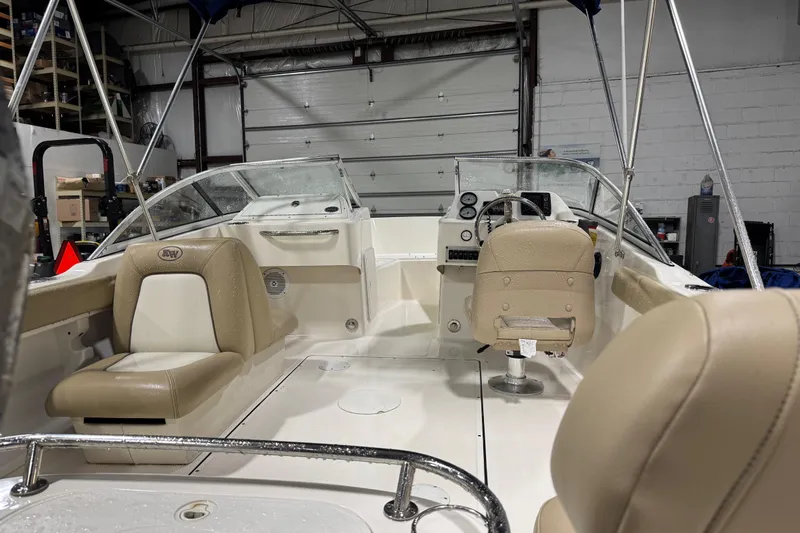 Slide: The Image of 2015 Key West 186 Dual Console boat interior with beige seating and steering wheel. - 10