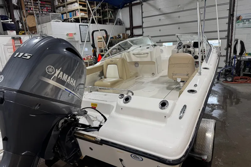 Slide: The Image of 2015 Key West 186 Dual Console boat with Yamaha 115 engine in a workshop. - 11