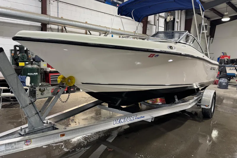 Slide: The Image of 2015 Key West 186 Dual Console boat on trailer in indoor storage. - 2