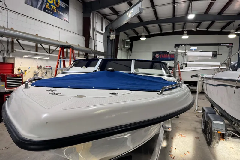 Slide: The Image of 2015 Key West 186 Dual Console boat in a workshop, covered and on a trailer. - 4