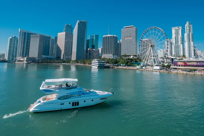 Slide: The Image of Azimut 48 Flybridge yacht cruising near city skyline and Ferris wheel, 2012 model. - 3