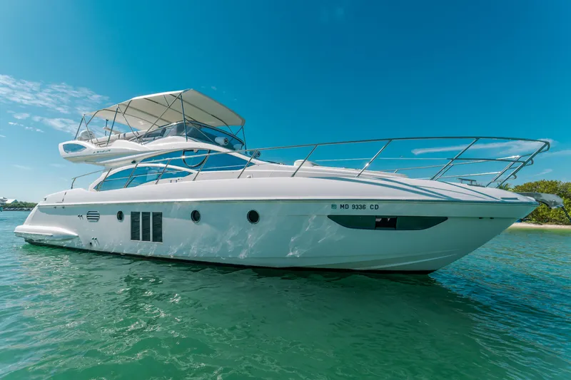 The Image of 2012 Azimut 48 Flybridge yacht on clear water under blue sky. - 0