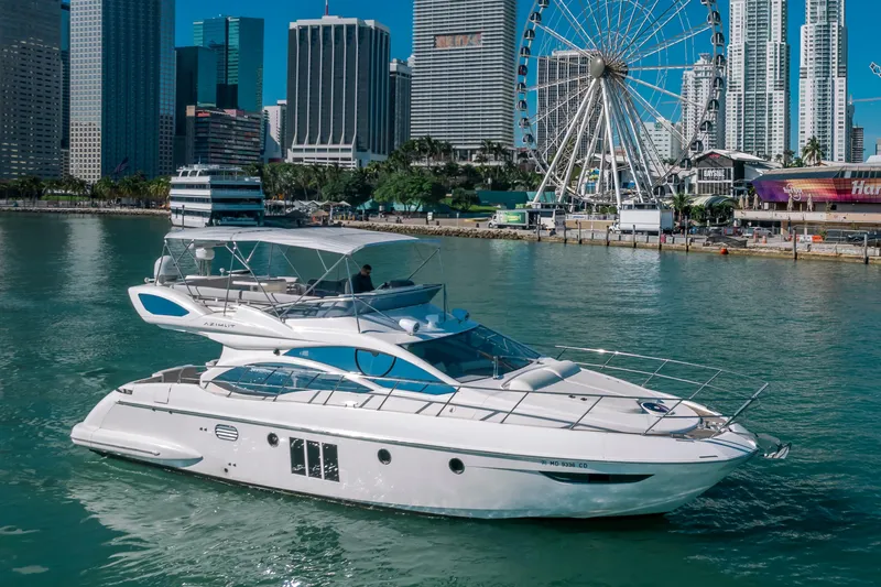 Slide: The Image of Azimut 48 Flybridge 2012 yacht cruising near city skyline and Ferris wheel. - 1