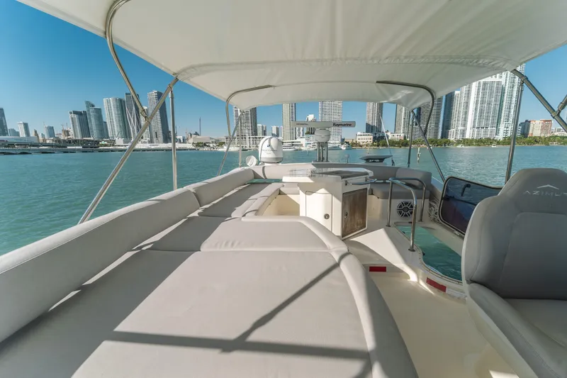 Slide: The Image of Luxurious 2012 Azimut 48 Flybridge yacht with city skyline view, spacious deck, and elegant seating. - 10