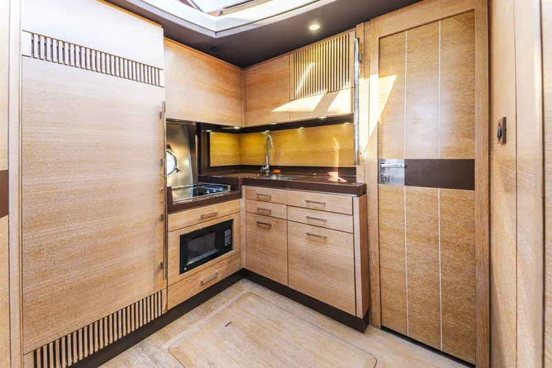Slide: The Image of Luxurious 2012 Azimut 48 Flybridge yacht kitchen with modern wood cabinetry and sleek appliances. - 15