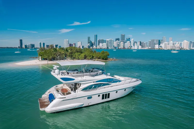 Slide: The Image of Azimut 48 Flybridge 2012 yacht near tropical island with city skyline in background. - 2