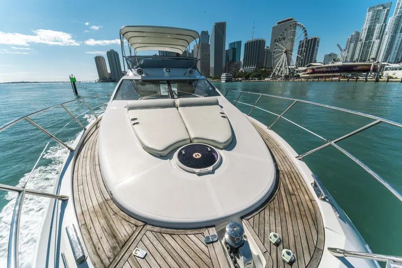 Slide: The Image of 2012 Azimut 48 Flybridge yacht cruising near city skyline and Ferris wheel. - 6