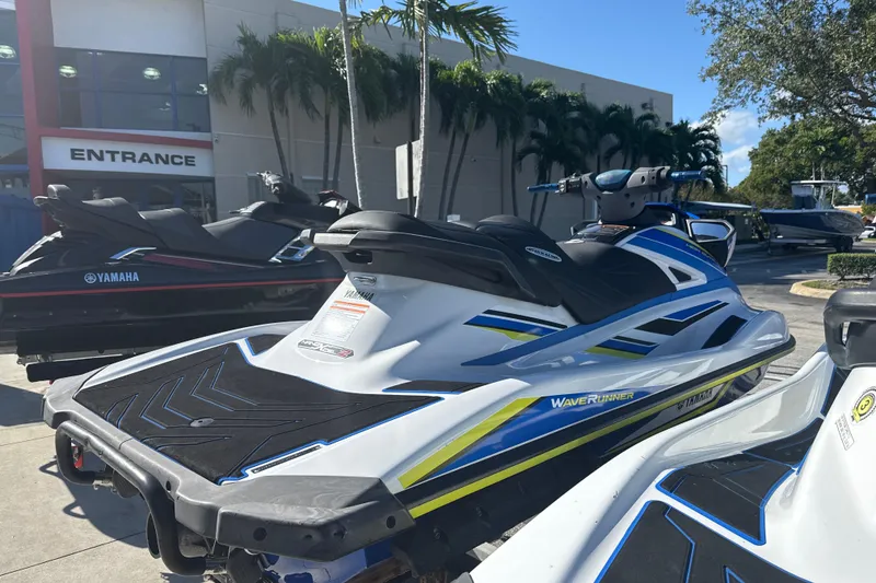 Slide: The Image of 2019 Yamaha WaveRunner VXR jet ski parked outside dealership with palm trees. - 6