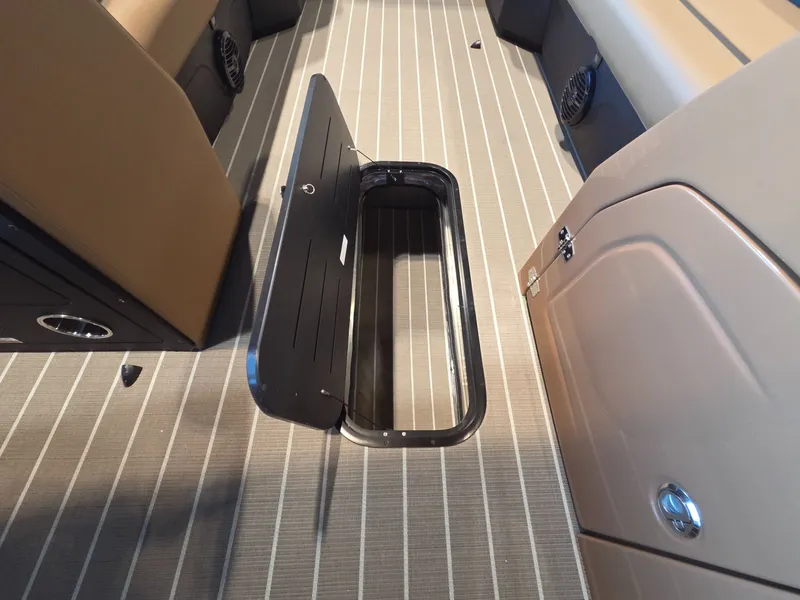 Slide: The Image of Interior of 2026 Bentley Pontoons Legacy 243 Navigator with open floor compartment. - 12