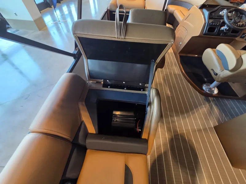 Slide: The Image of Interior of Bentley Pontoons Legacy 243 Navigator 2026 with open seat compartment. - 26