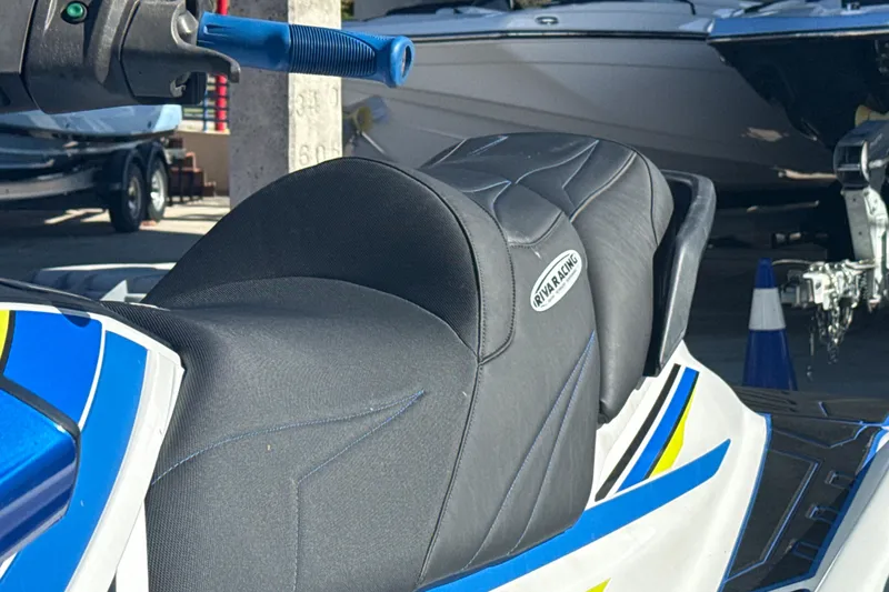 Slide: The Image of 2019 Yamaha WaveRunner VXR jet ski with blue and yellow accents in a storage area. - 5