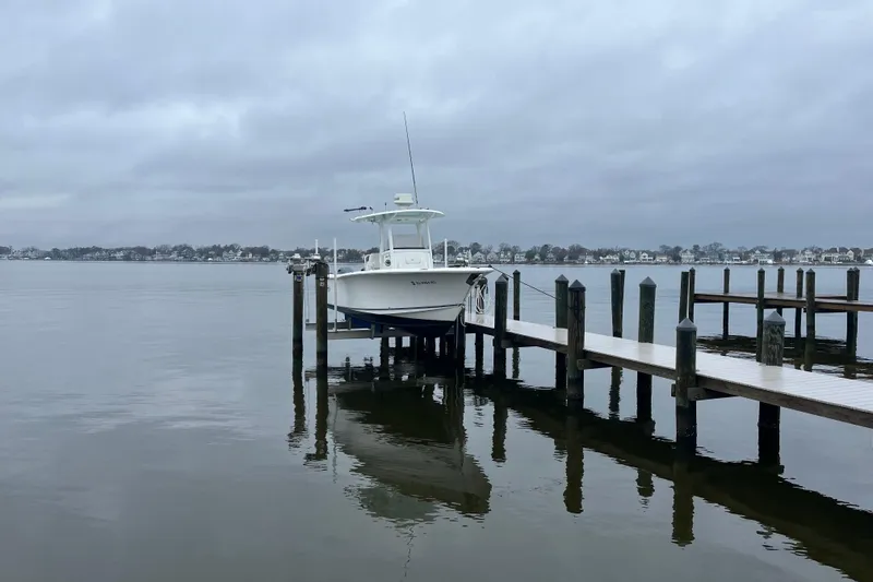 Slide: The Image of 2015 Sea Hunt Gamefish 27 boat docked on a calm, overcast day. - 12