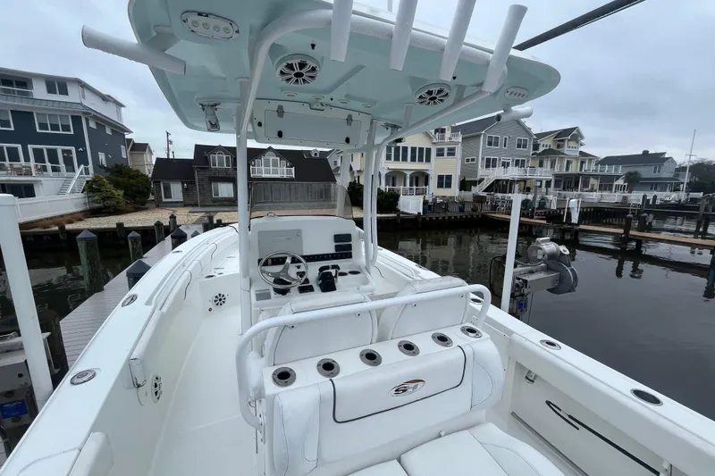 Slide: The Image of 2015 Sea Hunt Gamefish 27 boat docked near waterfront homes. - 6