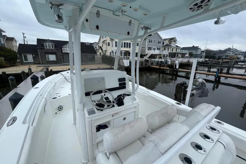 Slide: The Image of 2015 Sea Hunt Gamefish 27 boat docked near waterfront homes. - 8