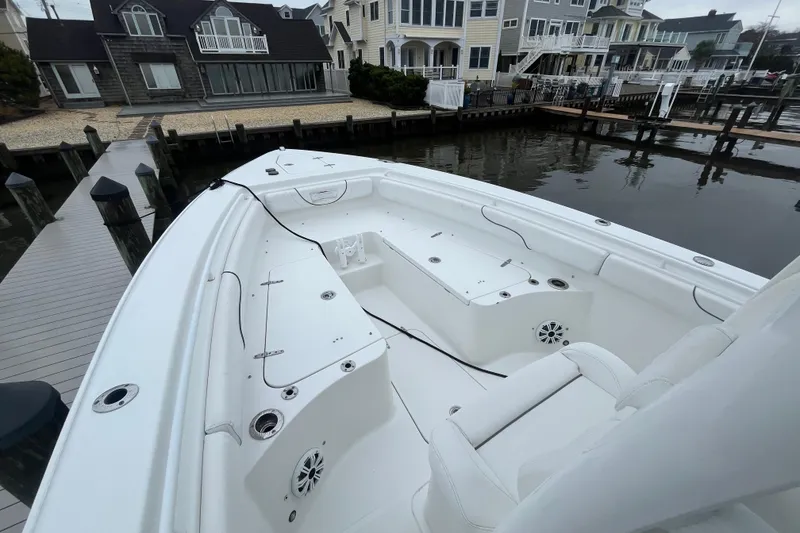 Slide: The Image of 2015 Sea Hunt Gamefish 27 boat docked near waterfront homes. - 9