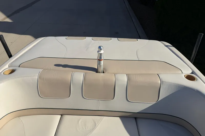 Slide: The Image of 1999 MasterCraft MariStar 210 VRS boat interior with beige upholstery and cup holders. - 11
