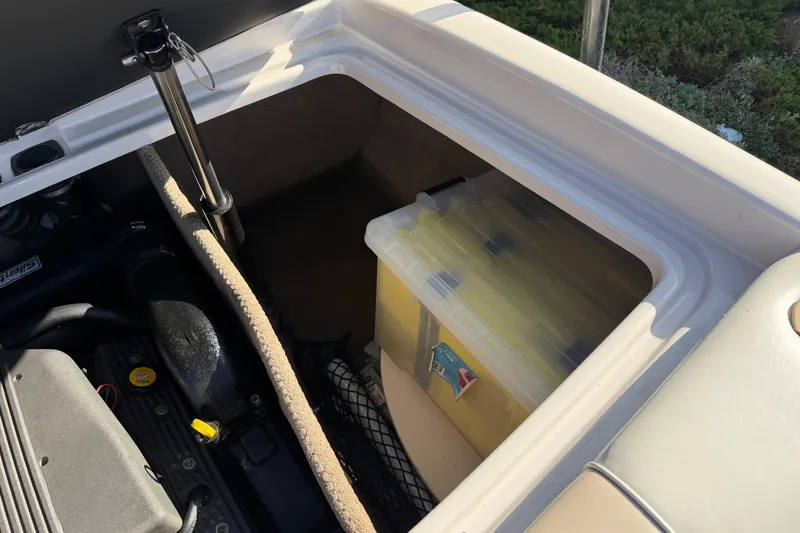 Slide: The Image of Open storage compartment in 1999 MasterCraft MariStar 210 VRS boat with yellow container. - 15